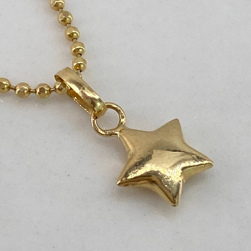 Dije Estrella  0.25gr / 1cm / Liso  Oro Amarillo $