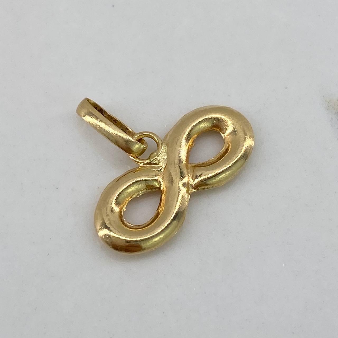 Dije Infinito  0.35gr / 1cm / Liso  Oro Amarillo $