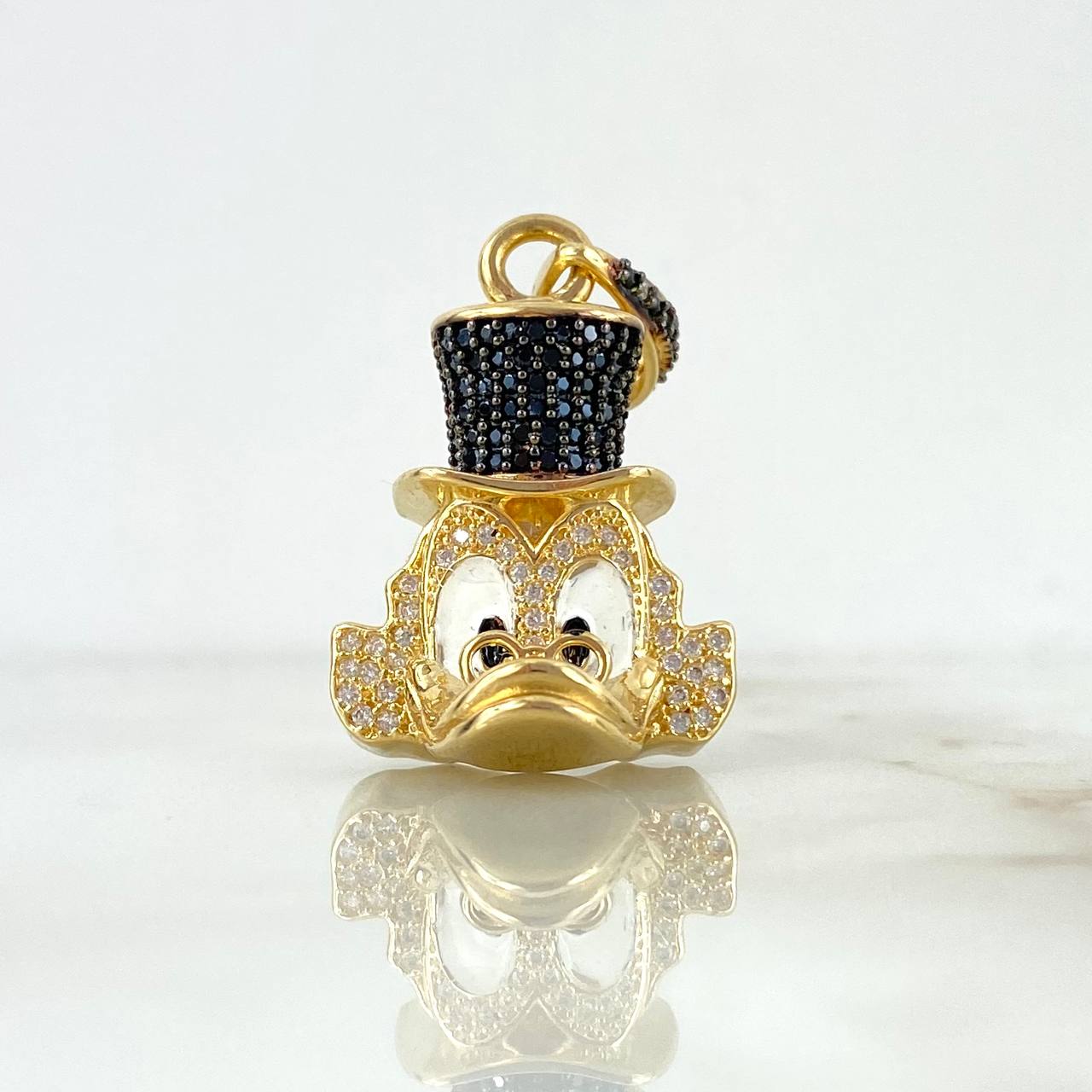 Dije Pato Millonario 8.9gr / 3.4cm / Circones Blancos y Negros Oro Amarillo ©