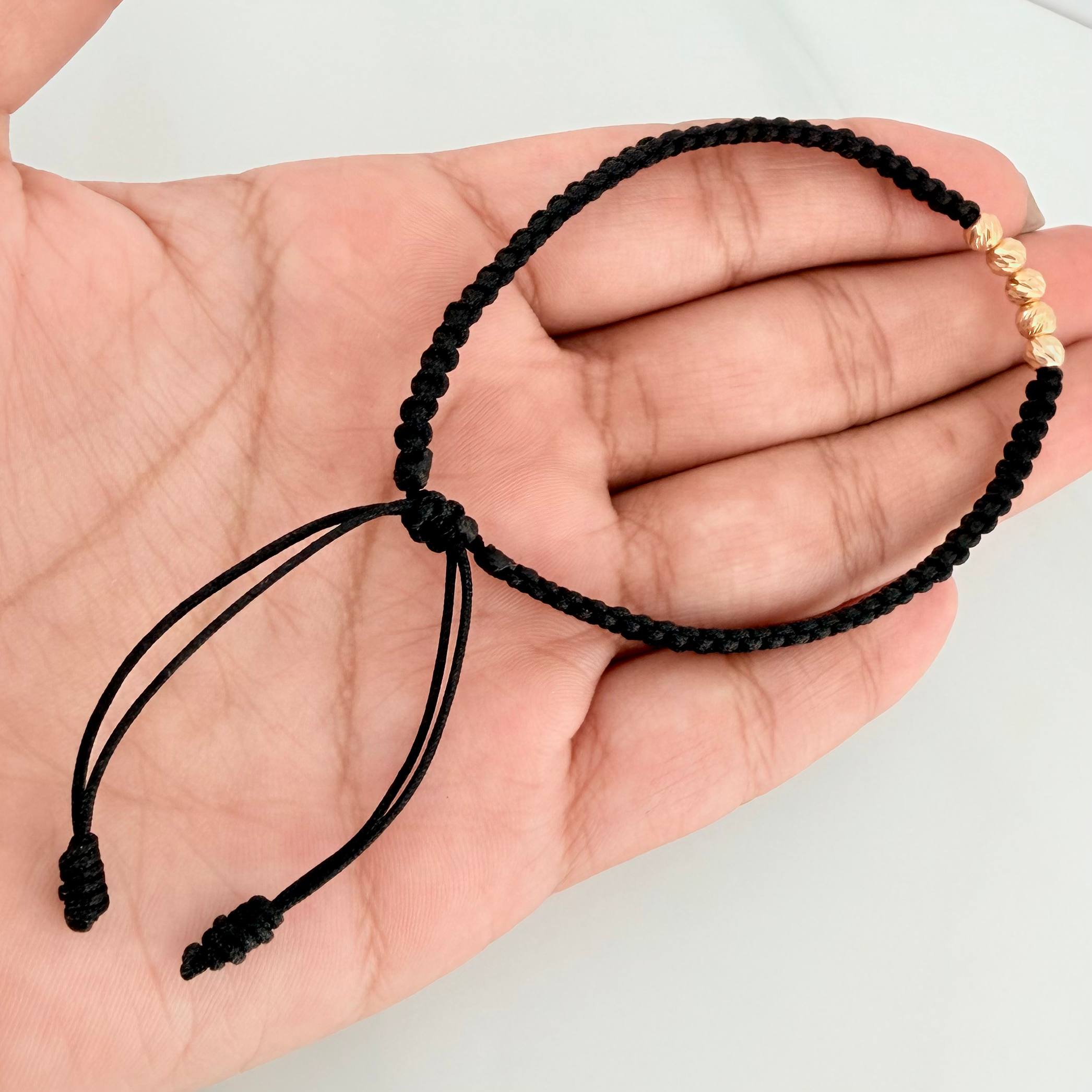 Pulsera Tejida Negra Bolas Diamantadas 4mm Oro Amarillo 18K