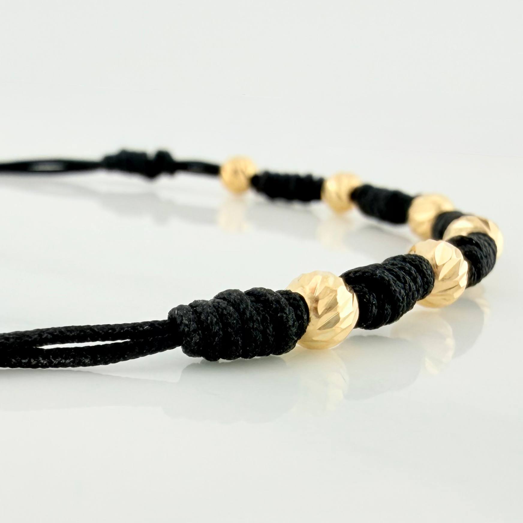 Pulsera Tejida Negra Bolas Diamantadas Oro Amarillo 18K
