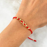 Pulsera Roja Infinito Atravezado 0.8gr / 4mm-3mm Bolas Lisas 6 und Oro Amarillo *