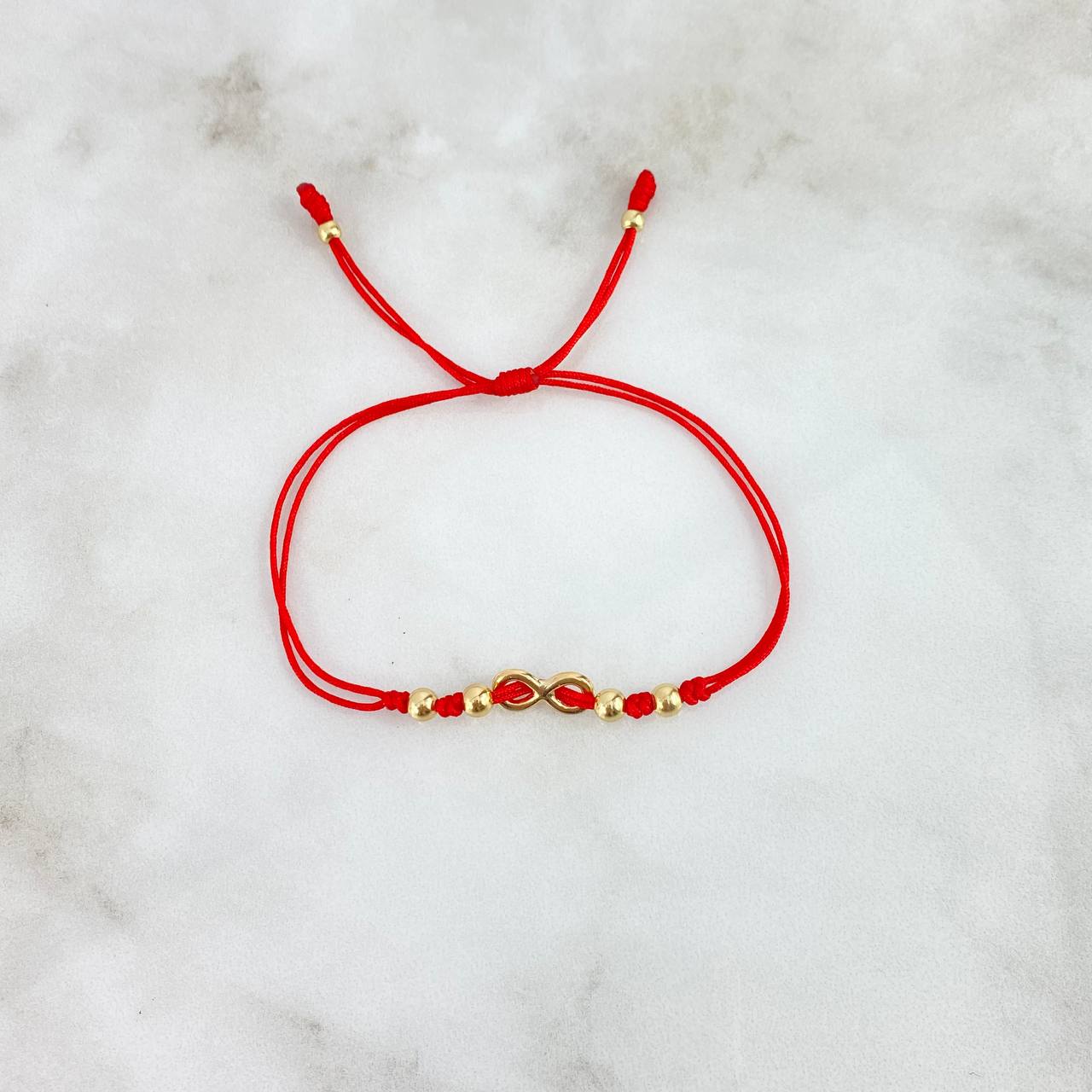 Pulsera Roja Infinito Atravezado 0.8gr / 4mm-3mm Bolas Lisas 6 und Oro Amarillo *