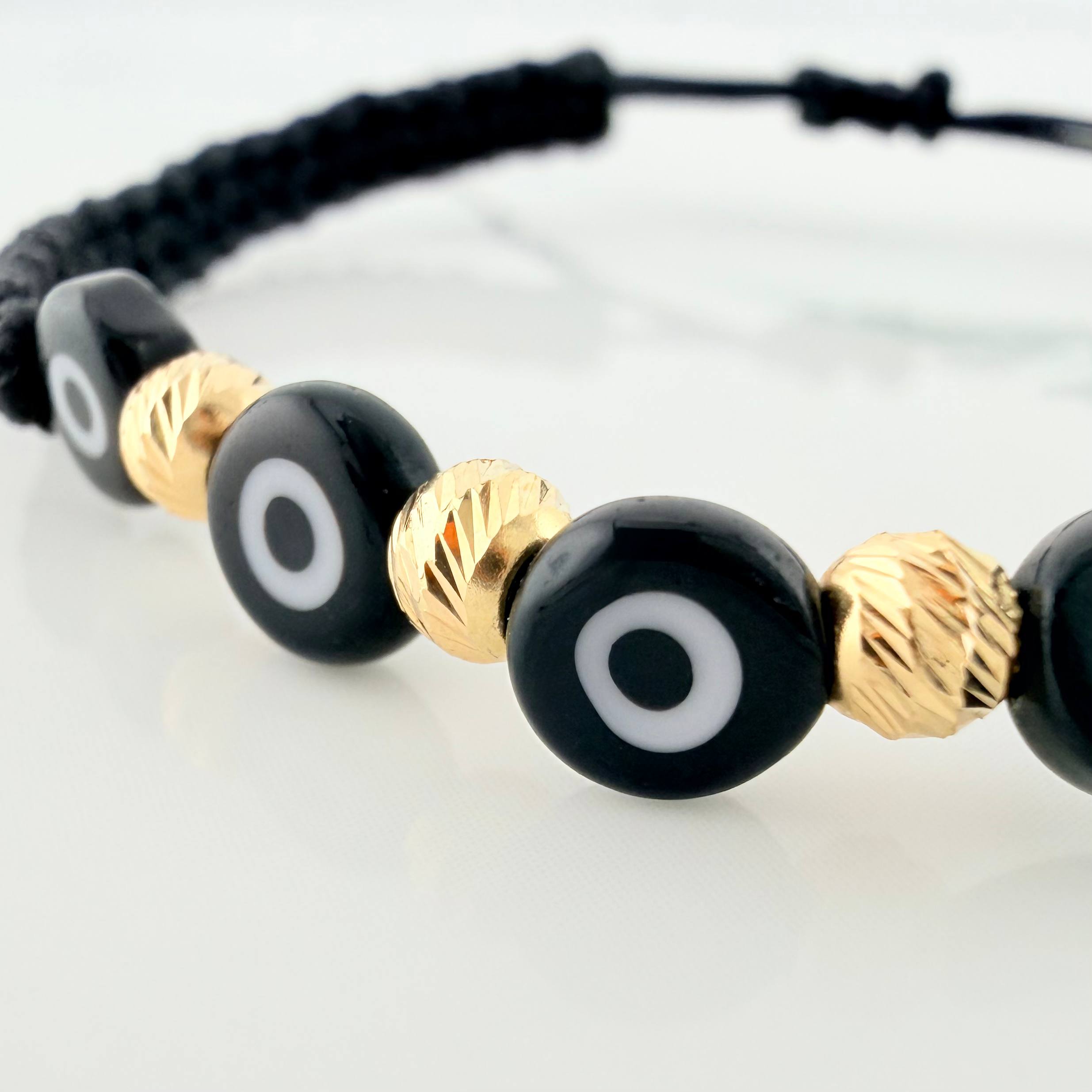 Pulsera Tejida Negra Ojos Turcos Negros Bolas Diamantadas 5Und Oro Amarillo 18K