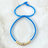 Pulsera Azul Herraje Cilindro Abultado Circones Blancos Negros 1.25gr / 4mm Bolas Diamantadas 4 und Lisas 4 und Oro Amarillo 18K *