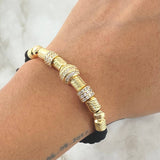 Pulsera Negra Herraje Rueda Abultada Circones Blancos  7.1gr / 6mm Bolas Diamantadas 2 und Cilindros 6und Oro Amarillo 18K ©