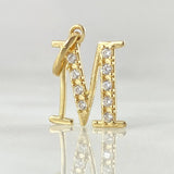 Dije Letra M Silueta 1.05gr / 1.8cm / Oro 18K ©