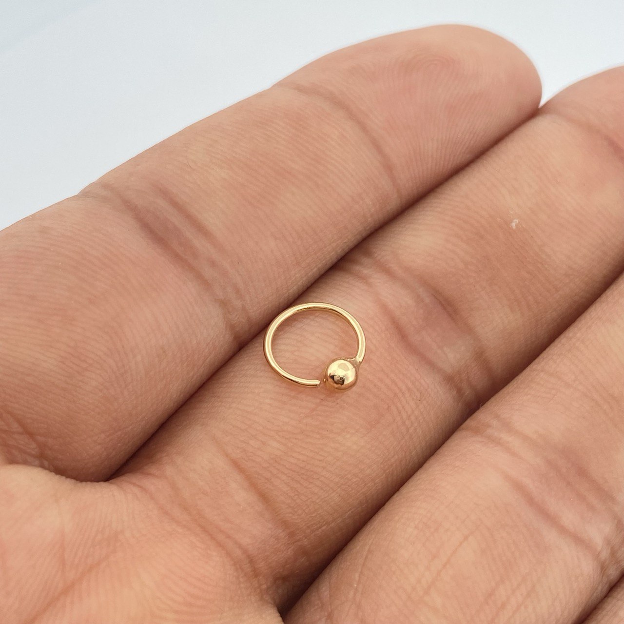Piercing Aro Bola 0.25gr / 1cm / Oro Amarillo 18K $