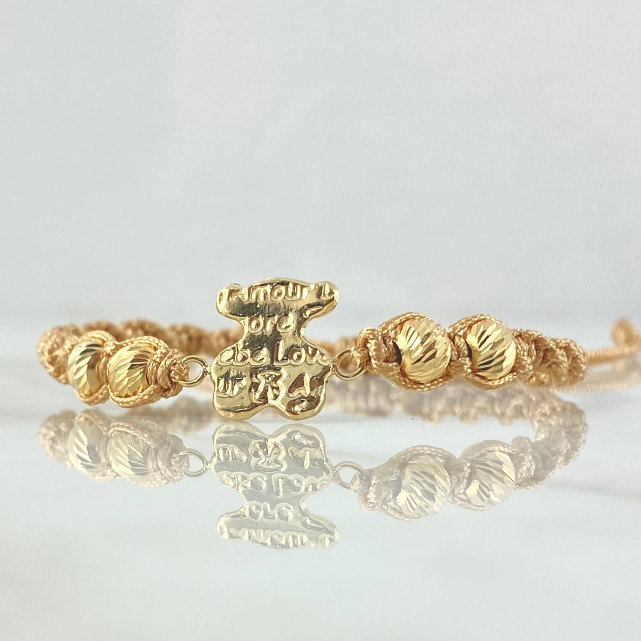 Pulsera Beige Herraje Oso Texturizado 1.15gr / 5mm Bolas Diamantadas 4und Oro Amarillo 18K ©