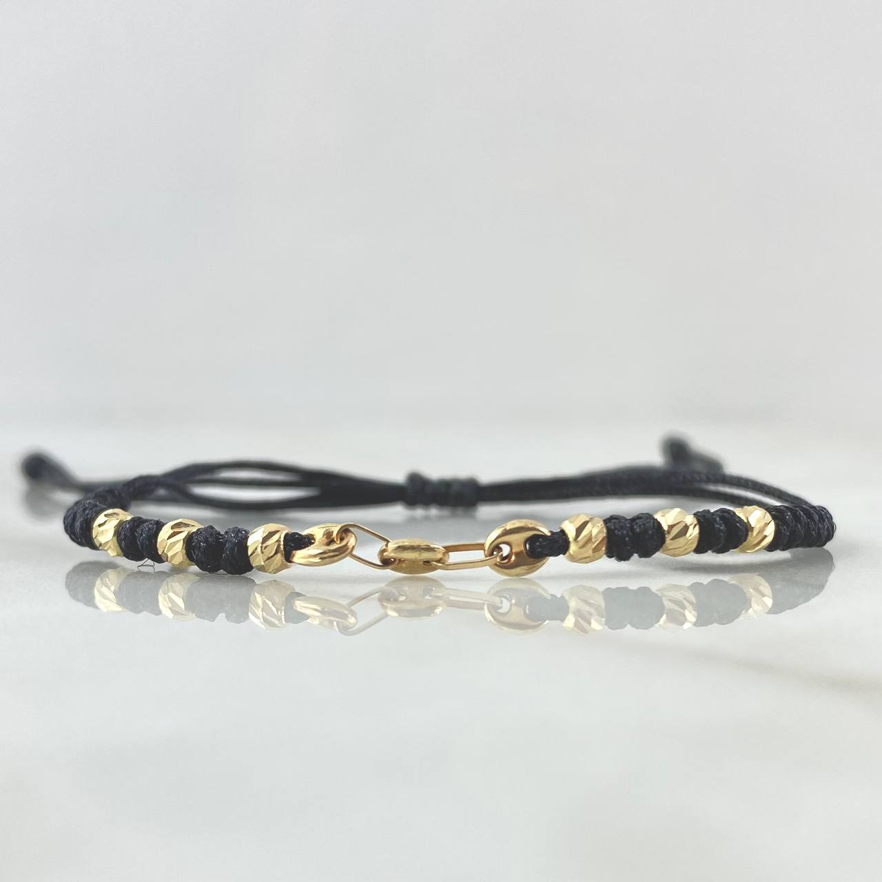 Pulsera Negra Retazo GC Liso 0.9gr / 3mm Bolas Diamantadas 6und Oro Amarillo 18K ©