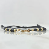 Pulsera Negra Retazo GC Liso 0.9gr / 3mm Bolas Diamantadas 6und Oro Amarillo 18K ©