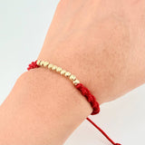 Pulsera Tejida Roja Bolas Diamantadas Oro Amarillo 18K