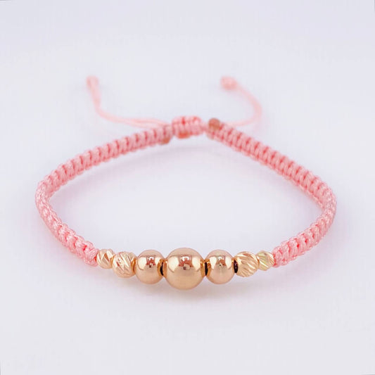 Pulsera Tejida Rosada Bolas Lisas/ Diamantadas Oro Amarillo 18K