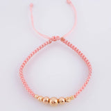 Pulsera Tejida Rosada Bolas Lisas/ Diamantadas Oro Amarillo 18K