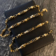 Cadena Rustica 29gr/65cm Cilindro Cauchos Negros Oro Amarillo