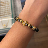 Pulsera Negra Calavera Supulcral Secciones Grisaseas Bolas 8mm Lisas Circones Blancos Oro Amarillo*